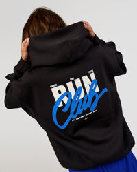 Woman wearing Run Club Script Oversized Hoodie - Black-Palace Blue | Model:Dakota | Size:XS | Thumbnail Index: 3