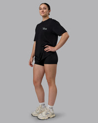 Woman wearing Run Love FLXCotton Oversized Tee - Black-Reflective | Model:Sav | Size:XS | Thumbnail Index: 5