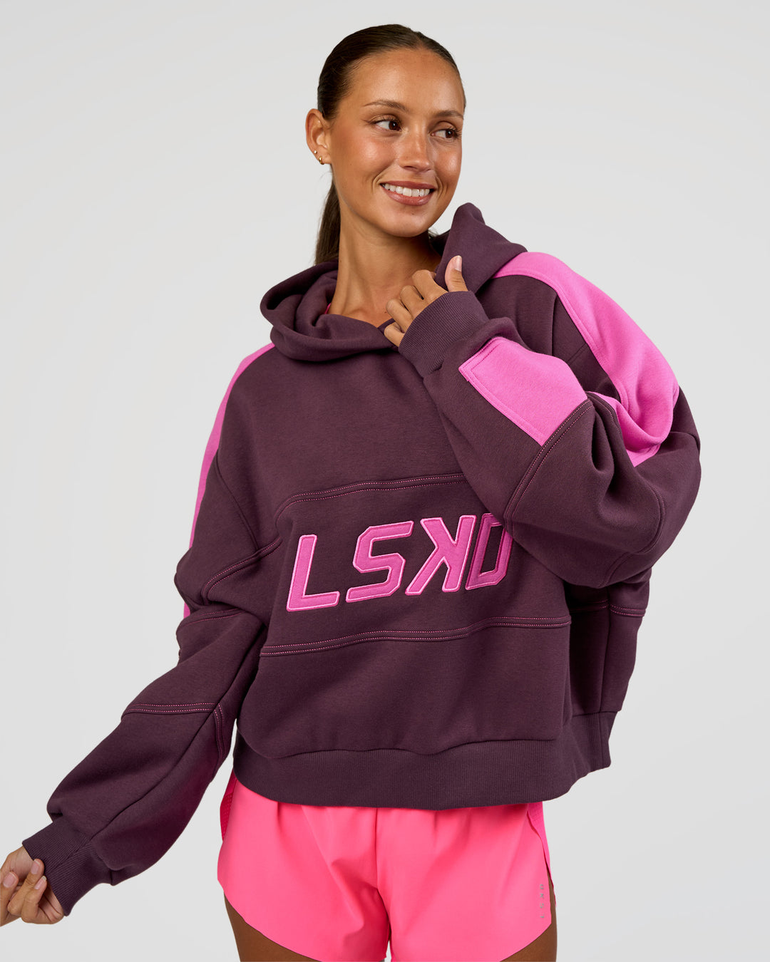 Woman wearing Slam Cropped Oversized Hoodie - Midnight Plum-Ultra Fuchsia | Model:Brylee | Size:XS - view 1