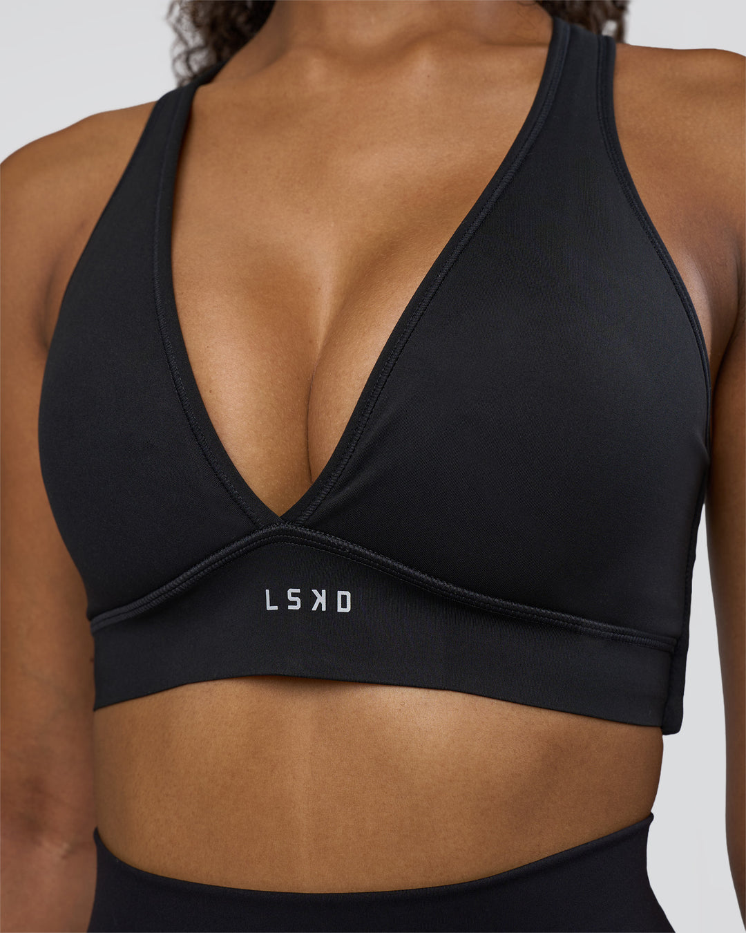 Woman wearing Stamina Sports Bra D/DD/E - Black | Model:Jordan | Size:XS - view 4