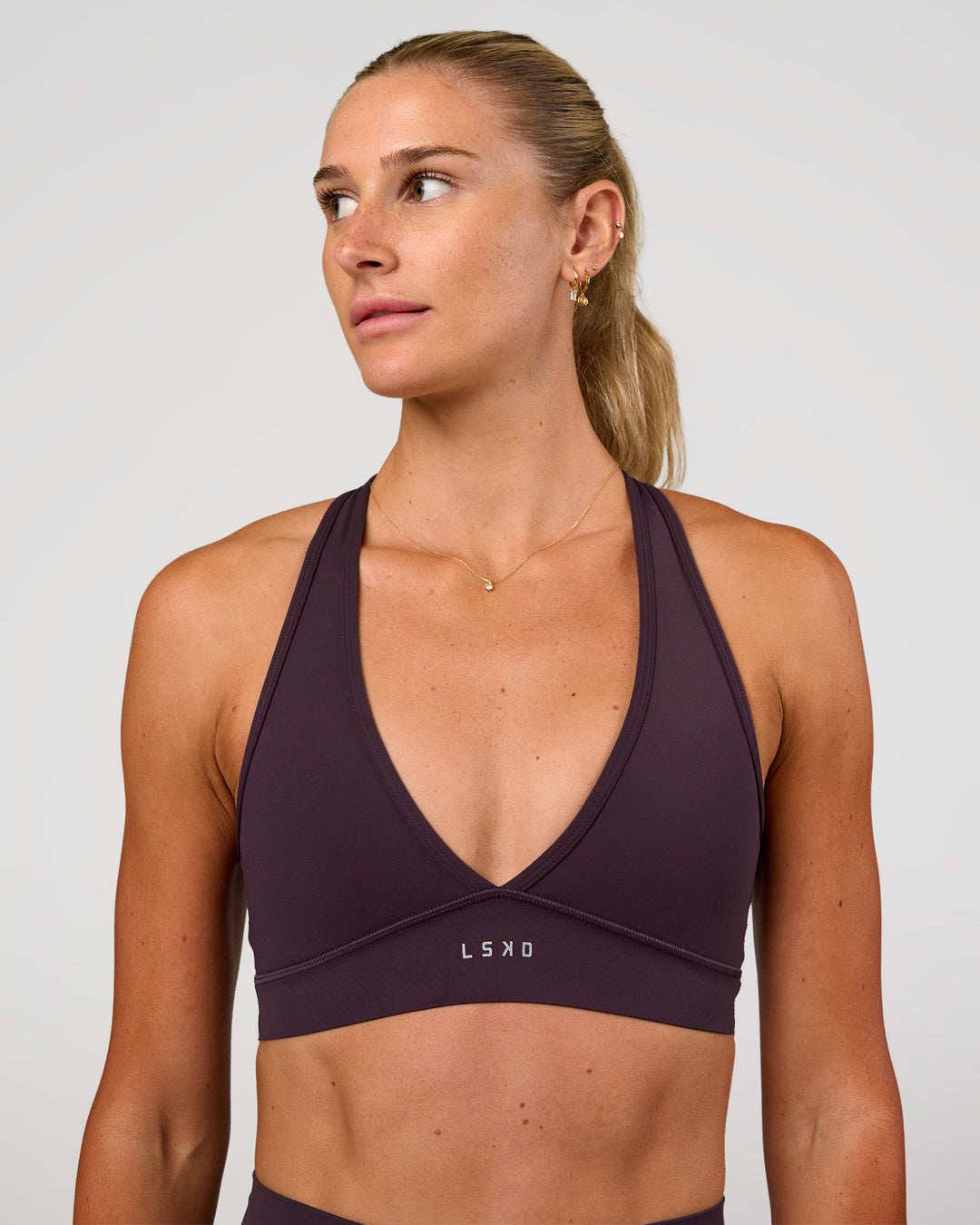 Woman wearing Stamina Sports Bra - Midnight Plum | Set:true | Angle:front | Model:Emelia | Size:XS - view 3