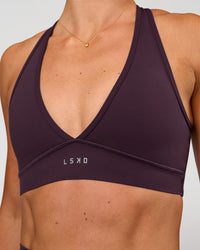 Woman wearing Stamina Sports Bra - Midnight Plum | Set:true | Angle:closeup | Model:Emelia | Size:XS | Thumbnail Index: 6