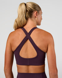 Woman wearing Stamina Sports Bra - Midnight Plum | Set:true | Angle:back | Model:Emelia | Size:XS | Thumbnail Index: 1