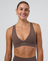 Woman wearing Stamina Sports Bra - Peppercorn | Set:true | Angle:front | Model:Emelia | Size:XS | Thumbnail Index: 0