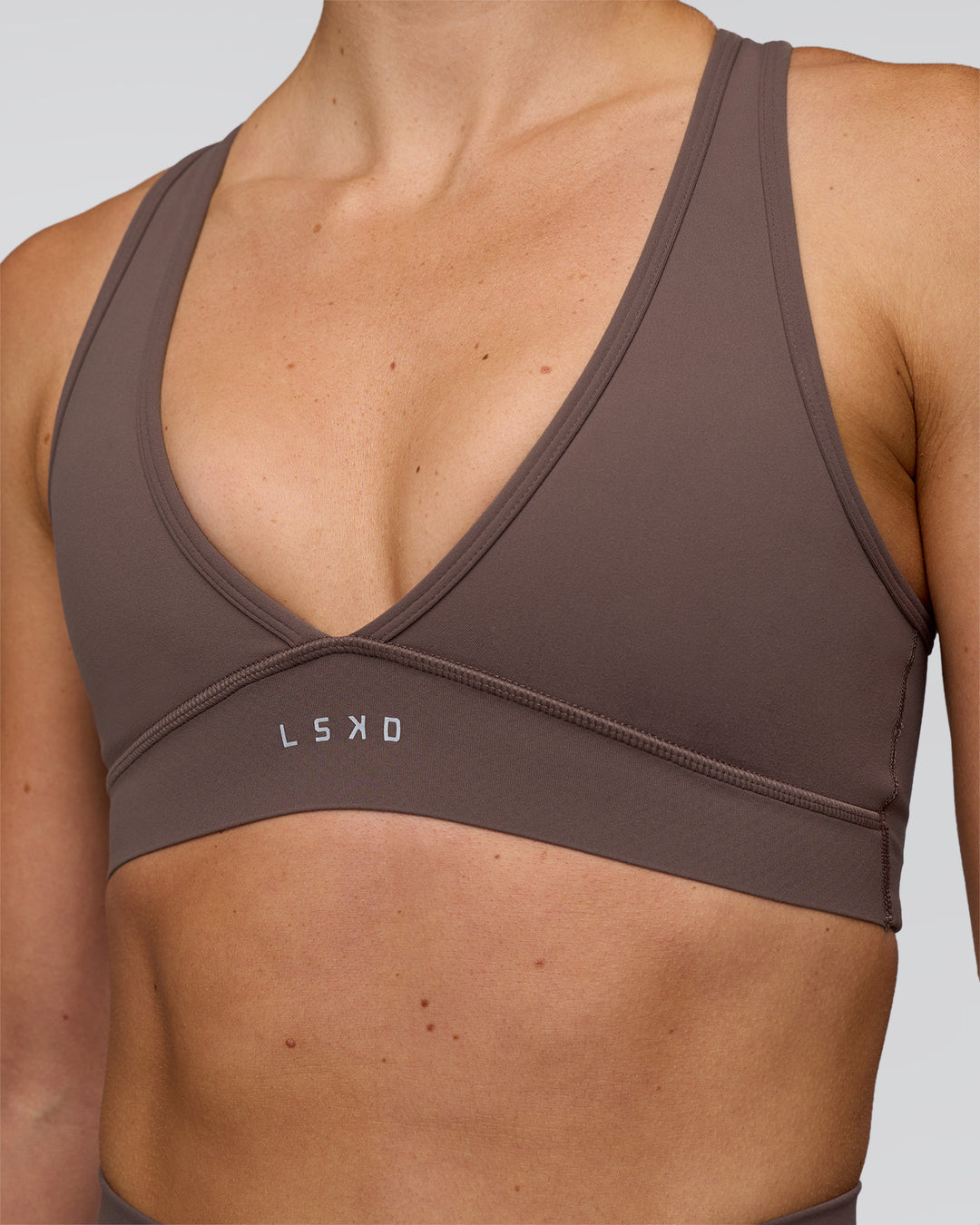 Woman wearing Stamina Sports Bra - Peppercorn | Set:true | Angle:closeup | Model:Emelia | Size:XS - view 5
