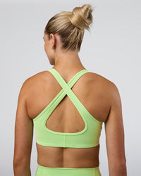Woman wearing Stamina Sports Bra - Solar Lime | Set:true | Angle:back | Model:Emelia | Size:XS | Thumbnail Index: 4