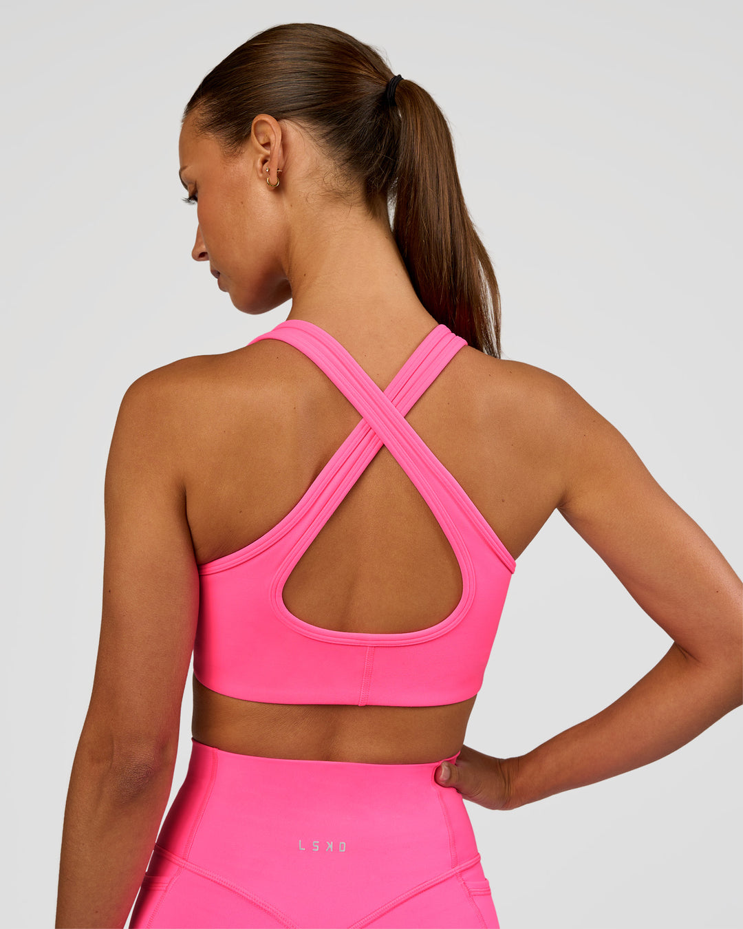 Woman wearing Stamina Sports Bra - Sugar Plum | Set:true | Angle:back | Model:Brylee | Size:XS - view 2