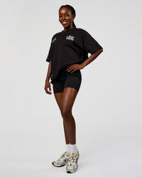 Woman wearing Static Grit Heavyweight Oversized Tee - Black-Alloy | Model:Ellie | Size:XS | Thumbnail Index: 4