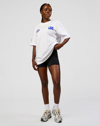 Woman wearing Static Grit Heavyweight Oversized Tee - White-Electric Indigo | Model:Ellie | Size:XS | Thumbnail Index: 11
