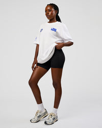 Woman wearing Static Grit Heavyweight Oversized Tee - White-Electric Indigo | Model:Ellie | Size:XS | Thumbnail Index: 4