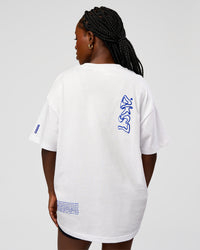 Woman wearing Static Grit Heavyweight Oversized Tee - White-Electric Indigo | Model:Ellie | Size:XS | Thumbnail Index: 7