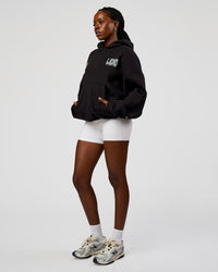 Woman wearing Static Grit Unisex Boxy Hoodie - Black-Alloy | Model:Ellie | Size:XS | Thumbnail Index: 8