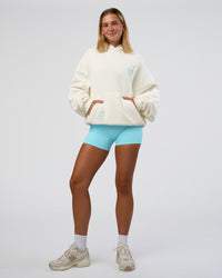 Woman wearing Sticker Unisex Oversized Hoodie - Off White-Jelly Mint | Model:Amity | Size:XS | Thumbnail Index: 11