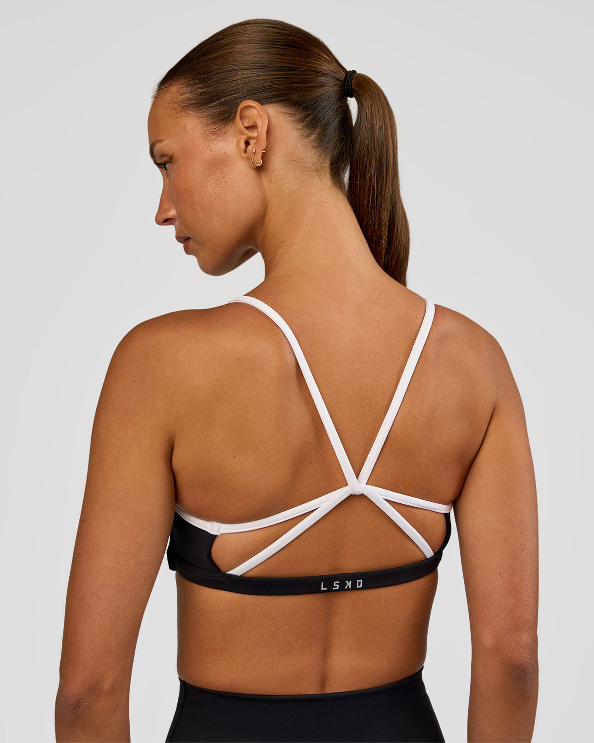 Woman wearing Tempo Sports Bra - Black-White | Model:Brylee | Size:XS