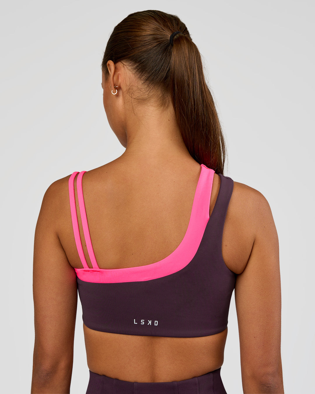Woman wearing Thrive Asymmetric Sports Bra - Midnight Plum-Sugar Plum | Model:Brylee | Size:XS - view 8