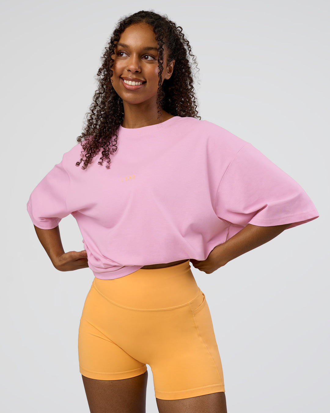 Woman wearing Together We Rise FLXCotton Oversized Tee - Bubblegum-Warm Apricot | Model:Jordan | Size:L - view 3