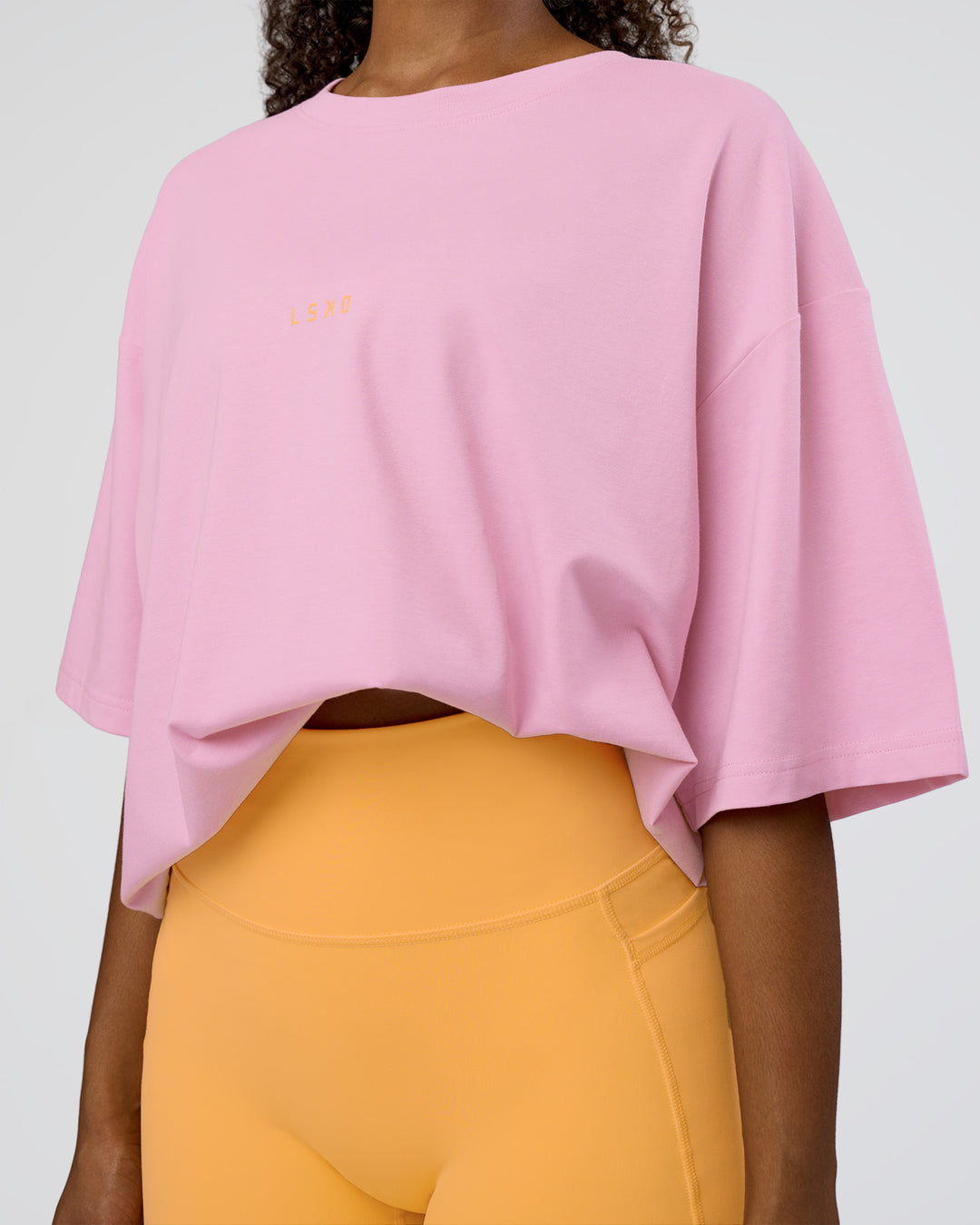 Woman wearing Together We Rise FLXCotton Oversized Tee - Bubblegum-Warm Apricot | Model:Jordan | Size:L - view 8