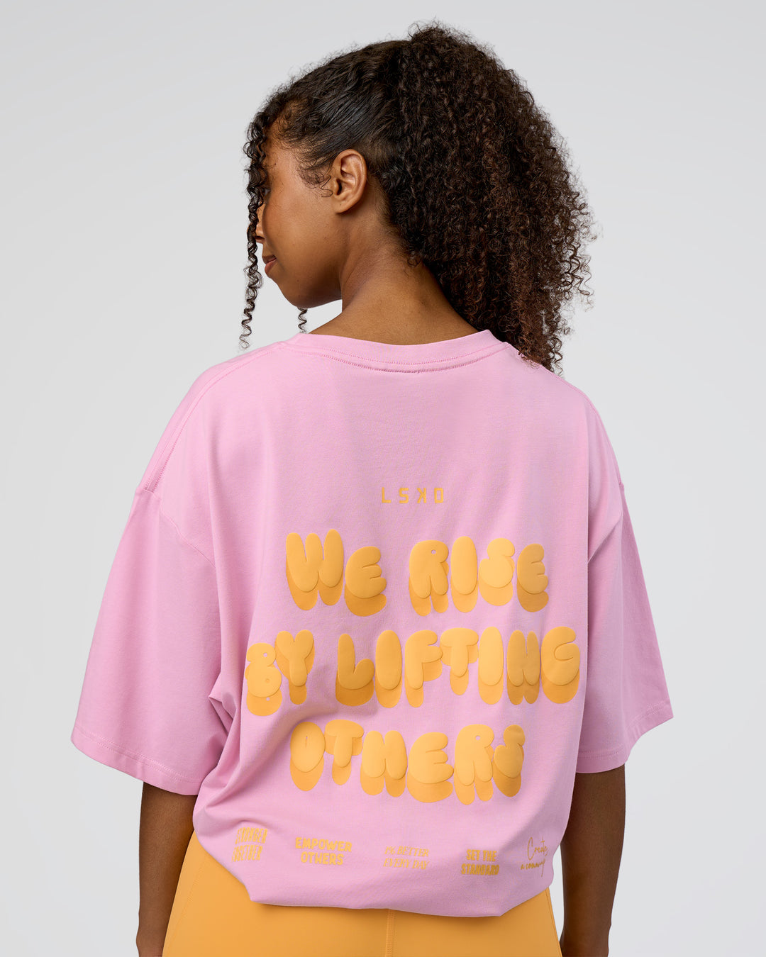 Woman wearing Together We Rise FLXCotton Oversized Tee - Bubblegum-Warm Apricot | Model:Jordan | Size:L - view 4
