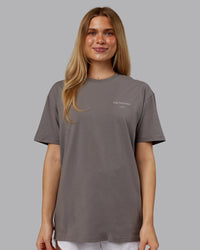 Woman wearing Trust The Process 2.0 FLXCotton Tee Oversize - Storm Front-Shale Beige | Model:Emilie | Size:XS | Thumbnail Index: 2