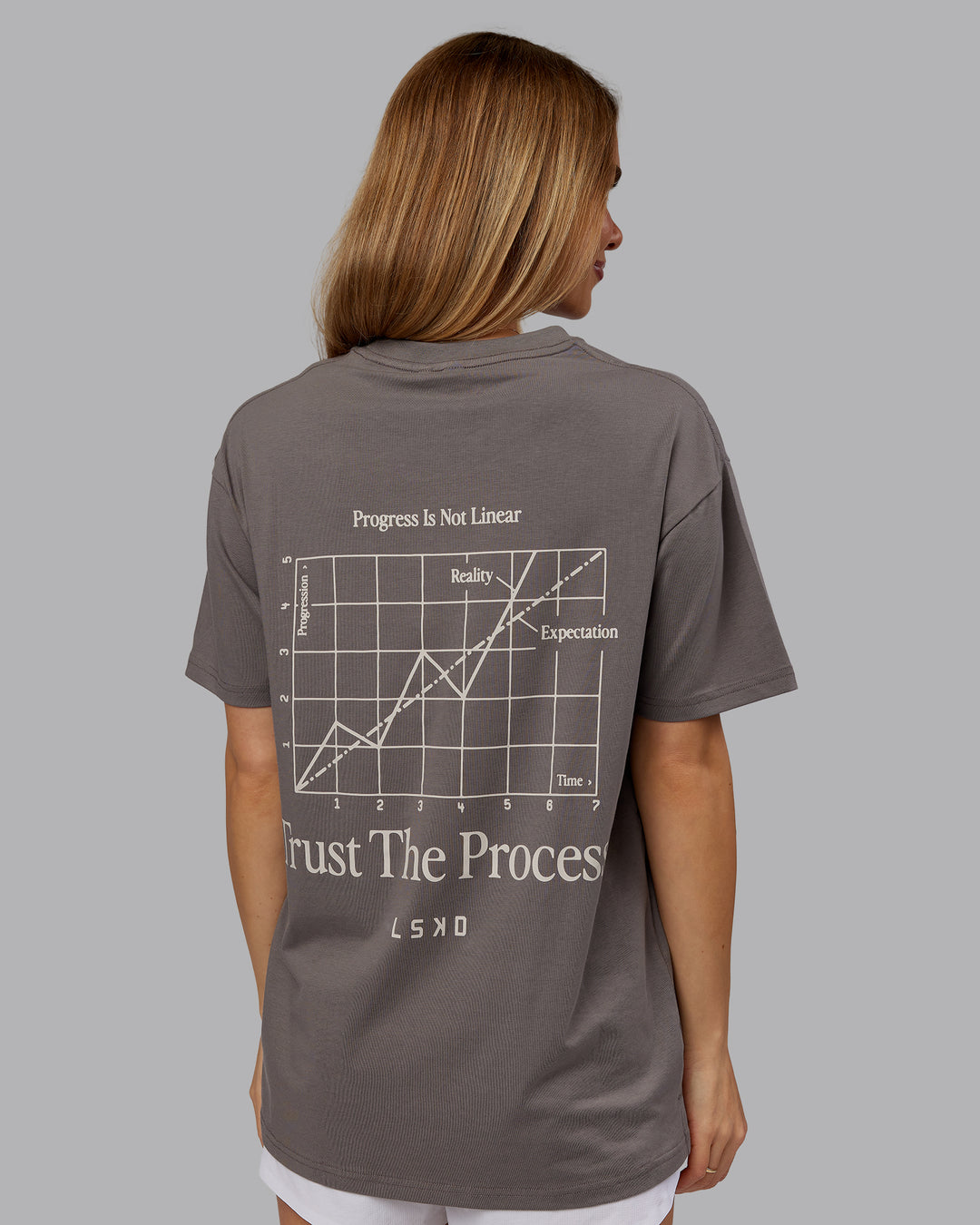Woman wearing Trust The Process 2.0 FLXCotton Tee Oversize - Storm Front-Shale Beige | Model:Emilie | Size:XS - view 7