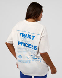 Woman wearing Trust The Process Heavyweight Unisex Oversized Tee - Off White-Electric Indigo | Model:Kirstyn | Size:XS | Thumbnail Index: 3