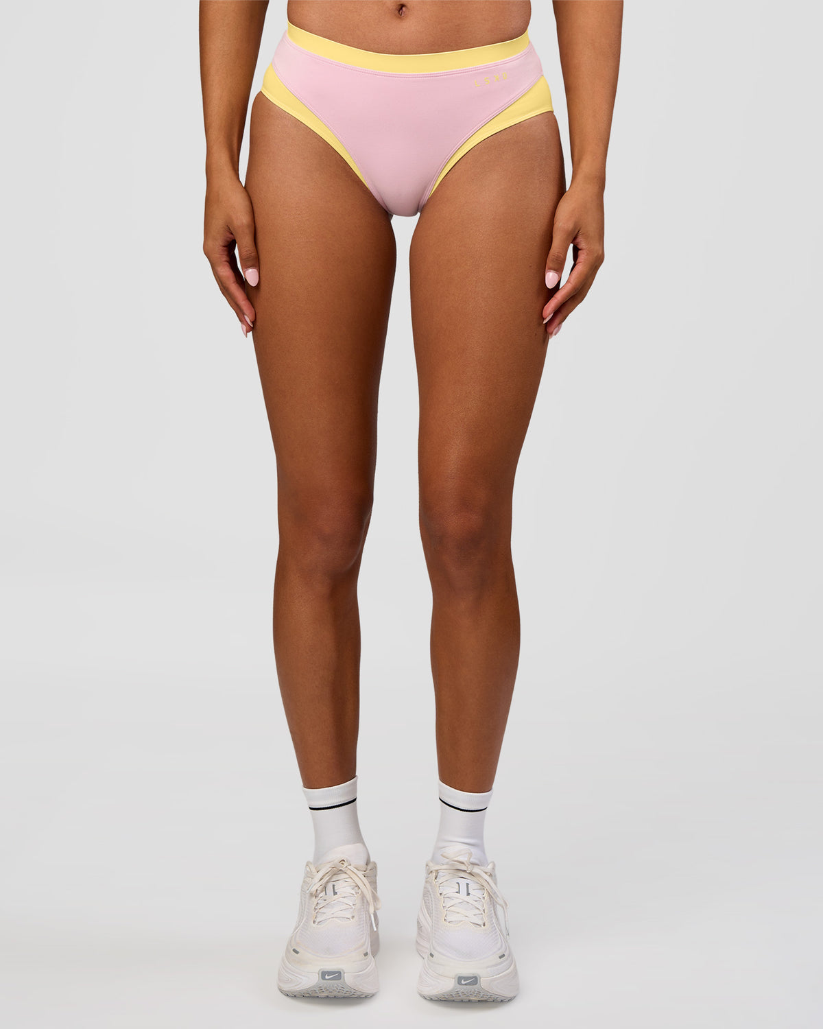 Woman wearing Turbo Track Brief in Marshmallow-Lemon | Model:Txai | Size:XS