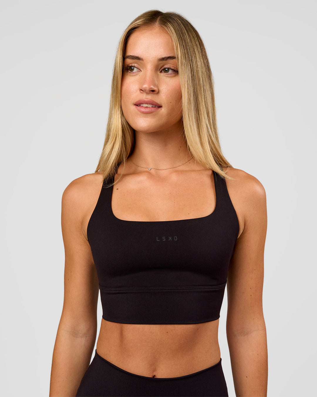 Woman wearing Twist Long Line Sports Bra in Black | Model:Issy | Size:XS - view 5