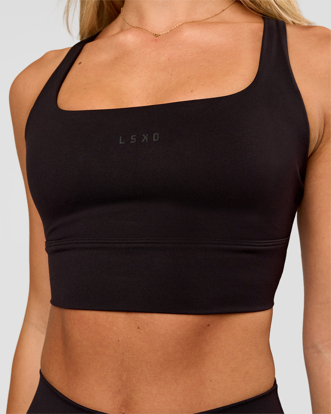 Woman wearing Twist Long Line Sports Bra in Black | Model:Issy | Size:XS - view 6
