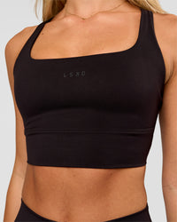 Woman wearing Twist Long Line Sports Bra in Black | Model:Issy | Size:XS | Thumbnail Index: 5