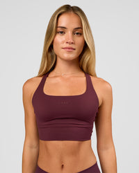 Woman wearing Twist Long Line Sports Bra in Cherry Lacquer | Model:Issy | Size:XS | Thumbnail Index: 5