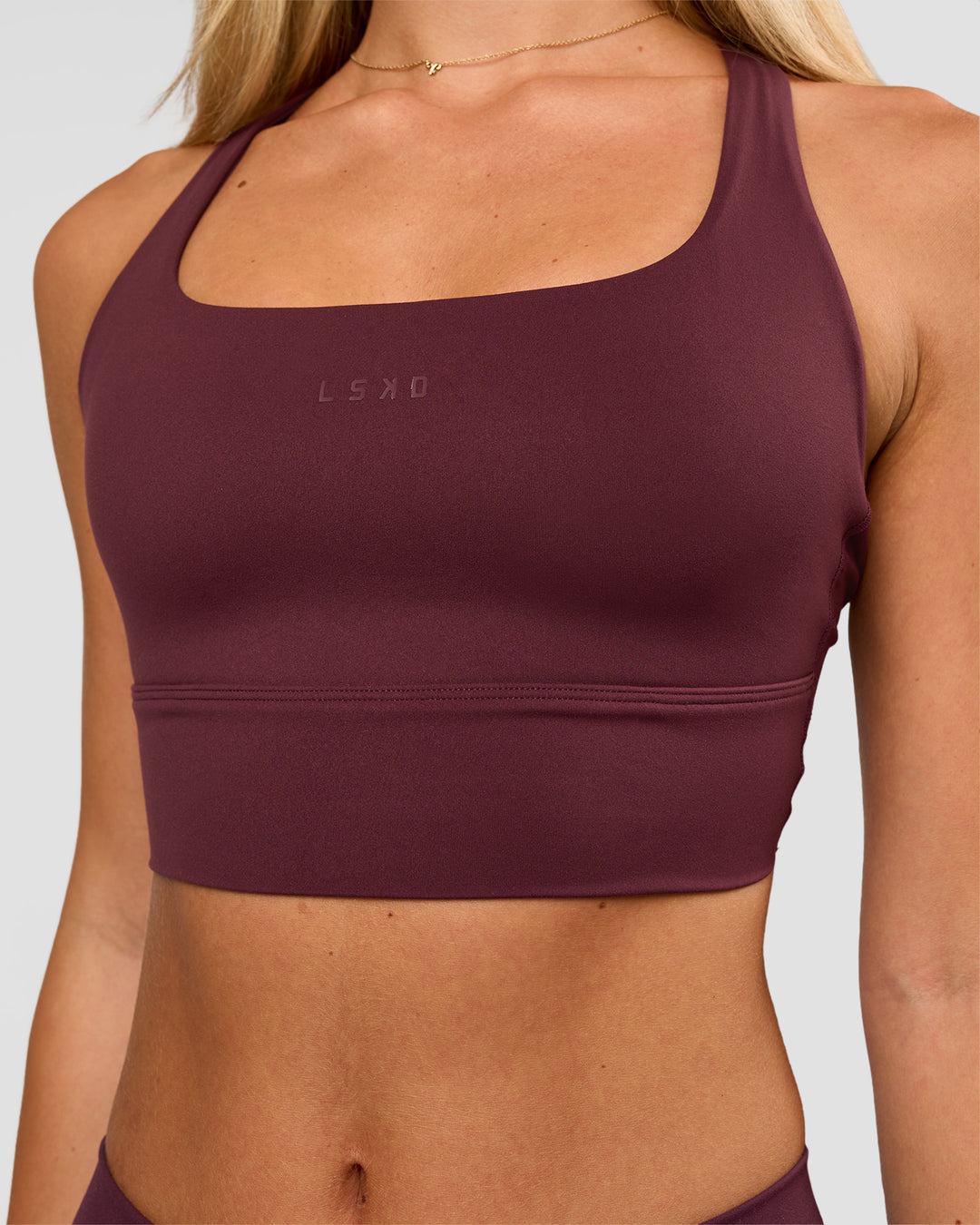 Woman wearing Twist Long Line Sports Bra in Cherry Lacquer | Model:Issy | Size:XS - view 2