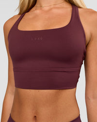 Woman wearing Twist Long Line Sports Bra in Cherry Lacquer | Model:Issy | Size:XS | Thumbnail Index: 1