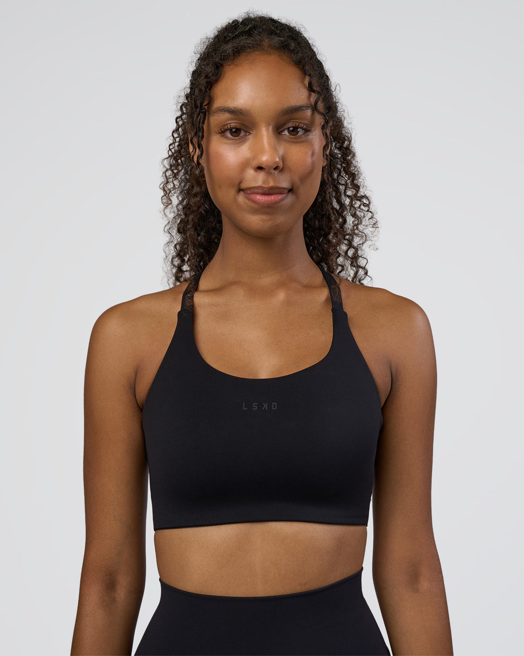 Woman wearing Twist Sports Bra D/DD/E - Black | Model:Jordan | Size:XS - view 2