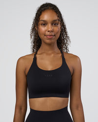 Woman wearing Twist Sports Bra D/DD/E - Black | Model:Jordan | Size:XS | Thumbnail Index: 1
