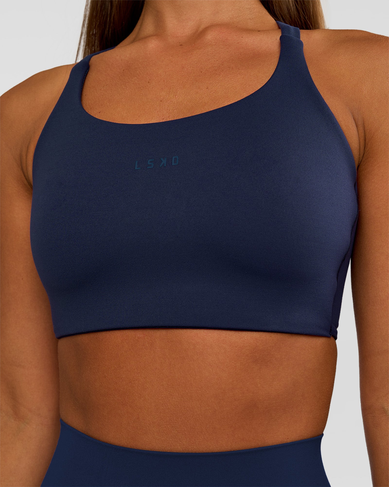 Woman wearing Twist Sports Bra D/DD/E - Future Navy | Model:Brylee | Size:XS