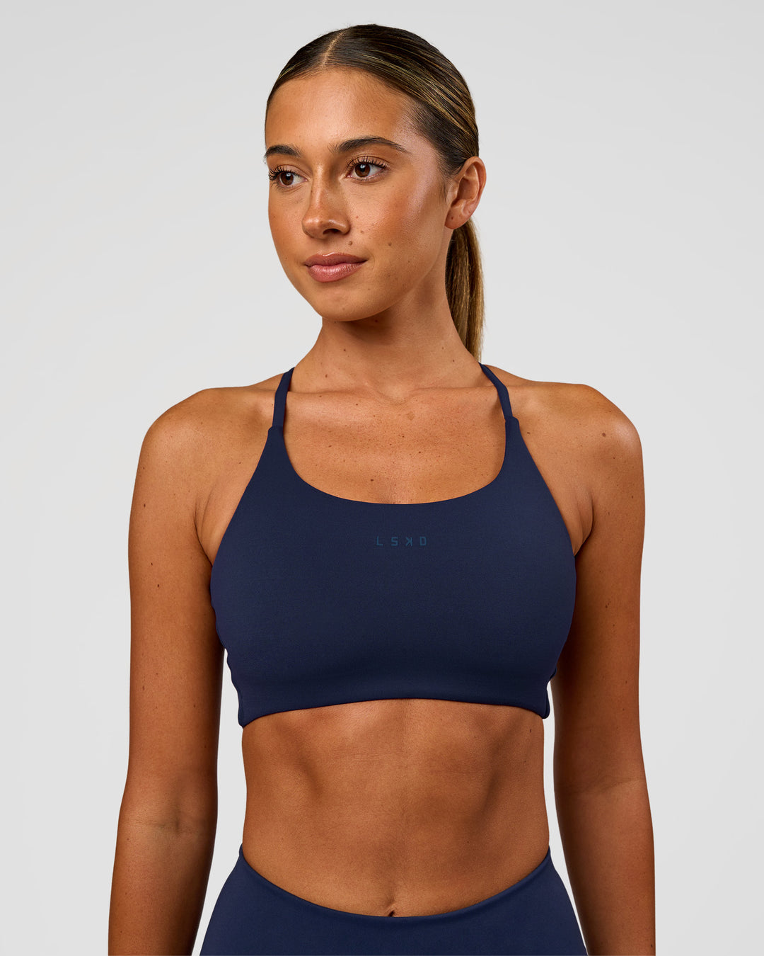 Woman wearing Twist Sports Bra - Future Navy | Model:Charli | Size:XS - view 1