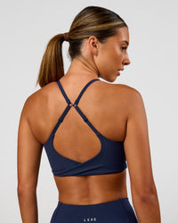 Woman wearing Twist Sports Bra - Future Navy | Model:Charli | Size:XS | Thumbnail Index: 2