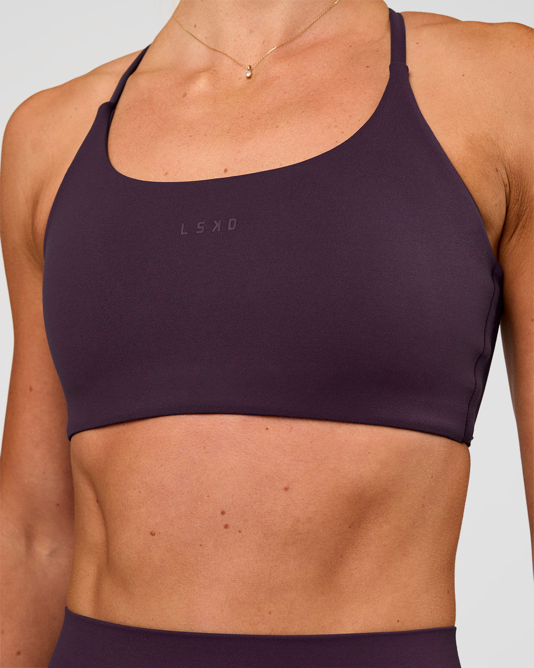 Woman wearing Twist Sports Bra - Midnight Plum | Model:Emelia | Size:XS - view 6