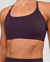 Woman wearing Twist Sports Bra - Midnight Plum | Model:Emelia | Size:XS | Thumbnail Index: 5