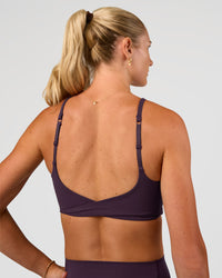 Woman wearing Twist Sports Bra - Midnight Plum | Model:Emelia | Size:XS | Thumbnail Index: 7