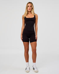 Woman wearing Twist Square Neck Shelf Bra Tank in Black | Model:Issy | Size:XS | Thumbnail Index: 4