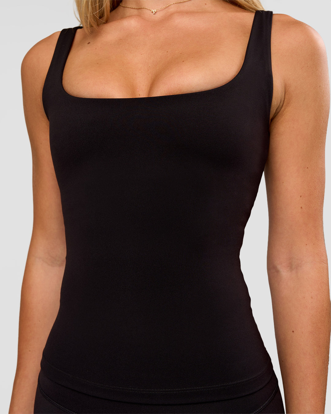 Woman wearing Twist Square Neck Shelf Bra Tank in Black | Model:Issy | Size:XS - view 8