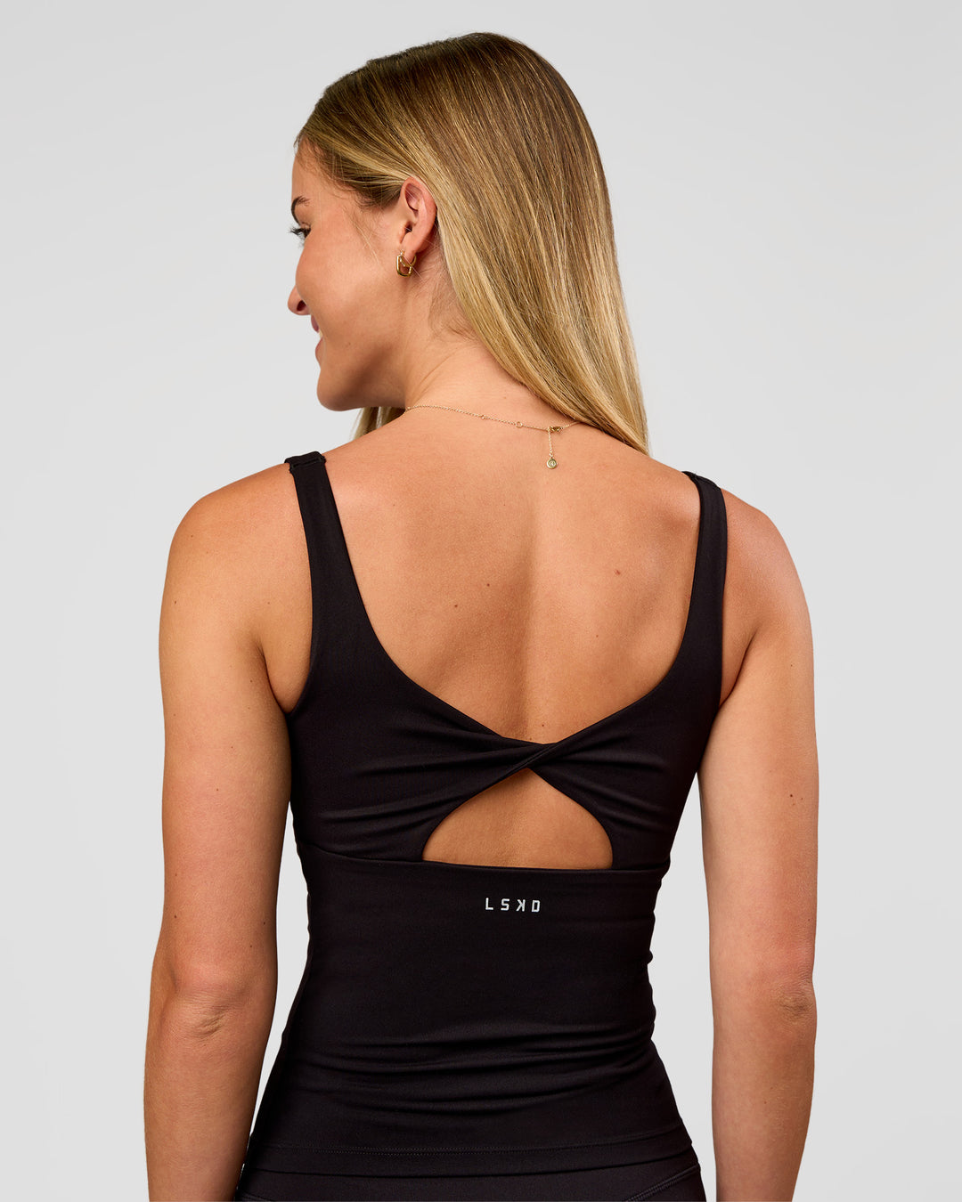 Woman wearing Twist Square Neck Shelf Bra Tank in Black | Model:Issy | Size:XS - view 4