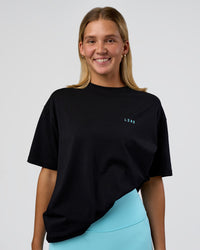 Woman wearing Unfit Club FLXCotton Oversized Tee - Black-White | Model:Amity | Size:XS | Thumbnail Index: 4