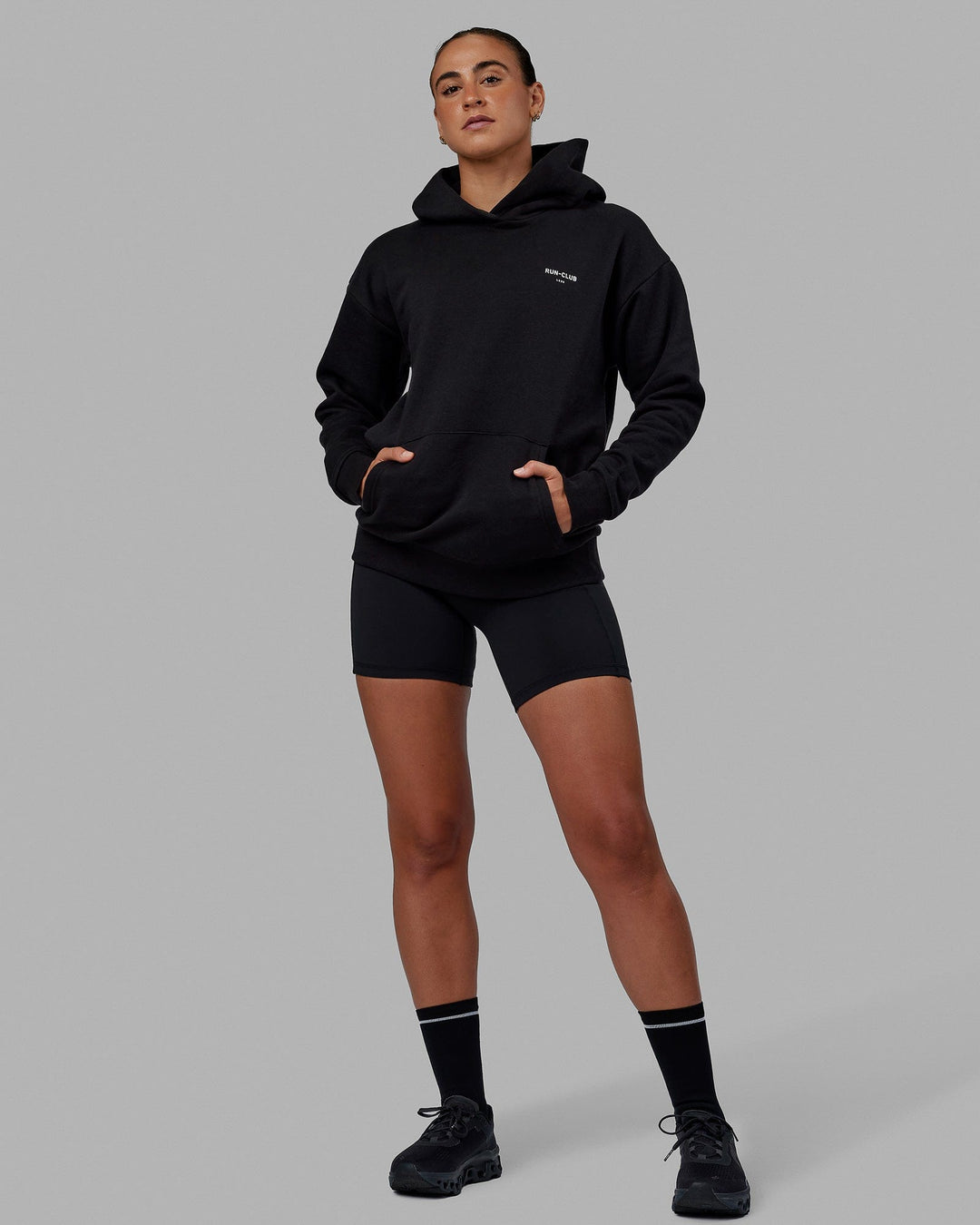 Woman wearing Unisex RUN-CLUB Hoodie Oversize - Black - view 11