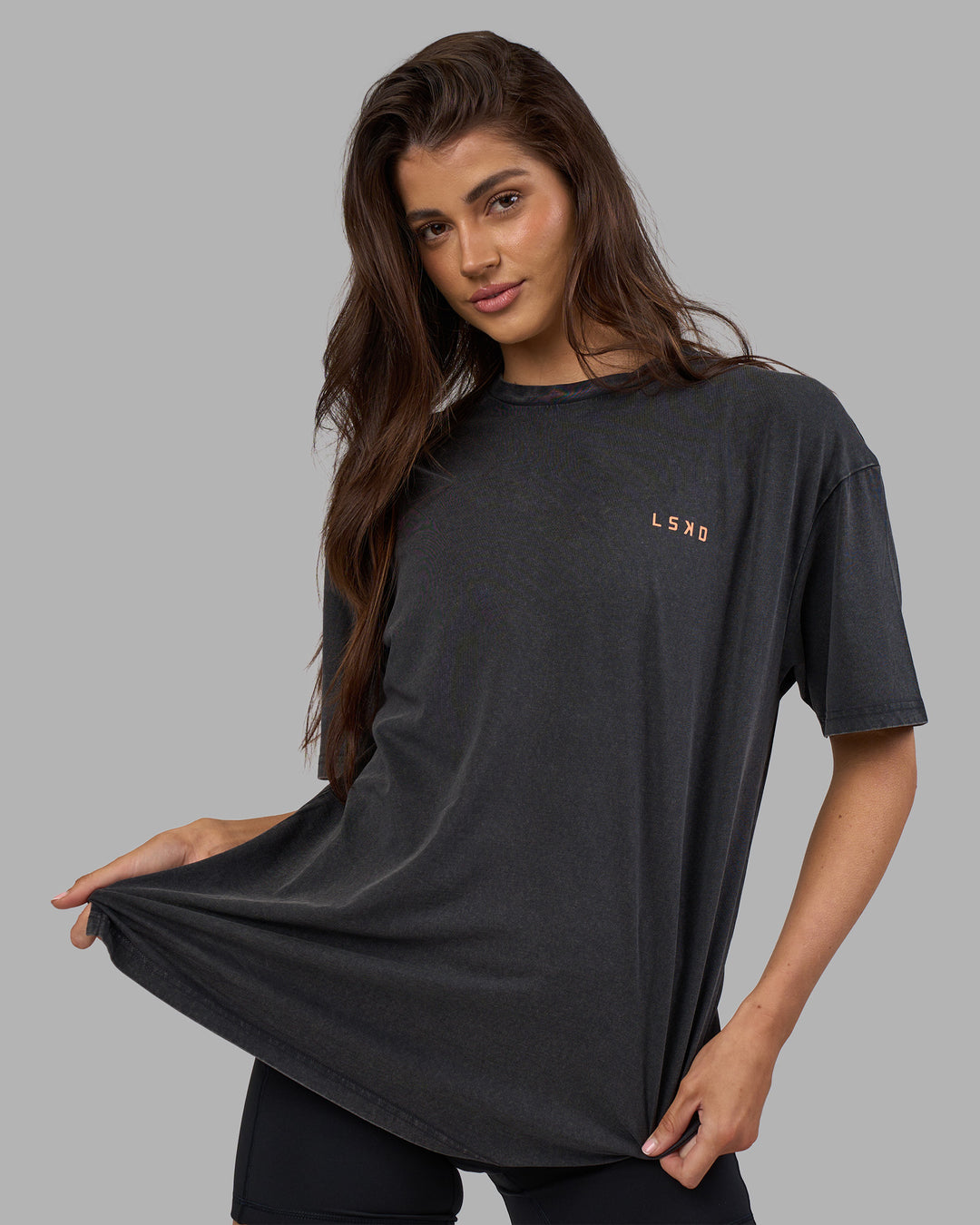 Woman wearing Unisex Strike Through FLXCotton Tee Oversize - Black Washed-Cantaloupe | Model:Phoebe | Size:XS - view 4