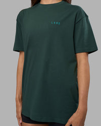 Woman wearing Unisex Strike Through FLXCotton Tee Oversize - Vital Green-Alexandrite | Model:Phoebe | Size:XS | Thumbnail Index: 7