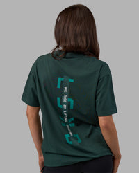 Woman wearing Unisex Strike Through FLXCotton Tee Oversize - Vital Green-Alexandrite | Model:Phoebe | Size:XS | Thumbnail Index: 1