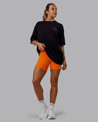 Woman wearing Unisex Trust The Process 2.0 FLXCotton Tee Oversize - Black-Vibrant Orange | Thumbnail Index: 10