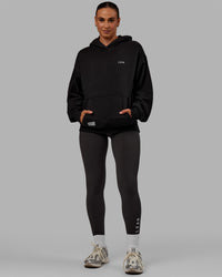 Woman wearing Unisex VS6 Hoodie Oversize - Black-White | Thumbnail Index: 8